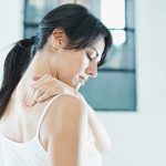 woman massaging neck. Side view, copy space